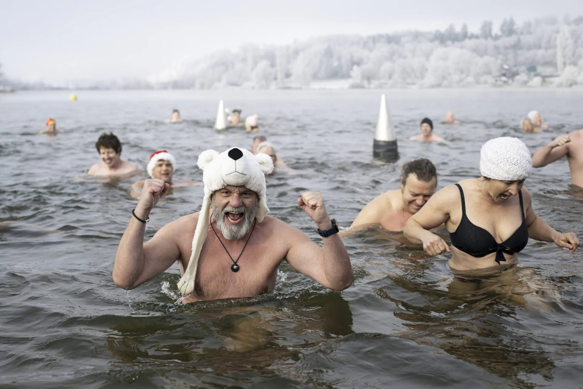 Swimmers attend the traditional New Year's Eve swimming at lake Moossee in Moosseedorf, Switzerland, Tuesday, December 31, 2024. (Anthony Anex/Keystone via AP)