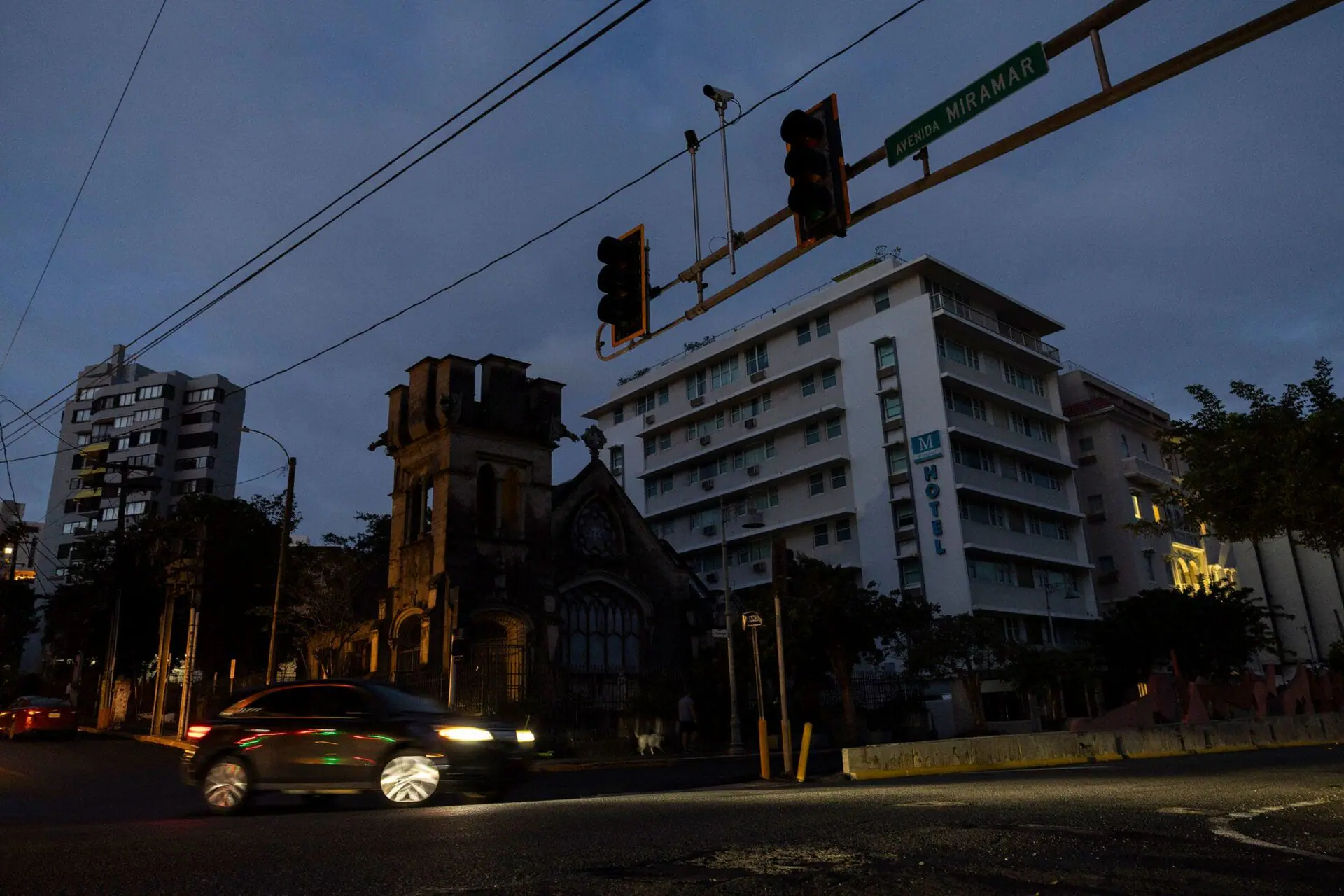 A car navigates an intersection without working stop lights in San Juan, Puerto Rico, after a major power outage hit the island on Tuesday. (Photo by Ricardo Arduengo/AFP/Getty Images via CNN Newsource)