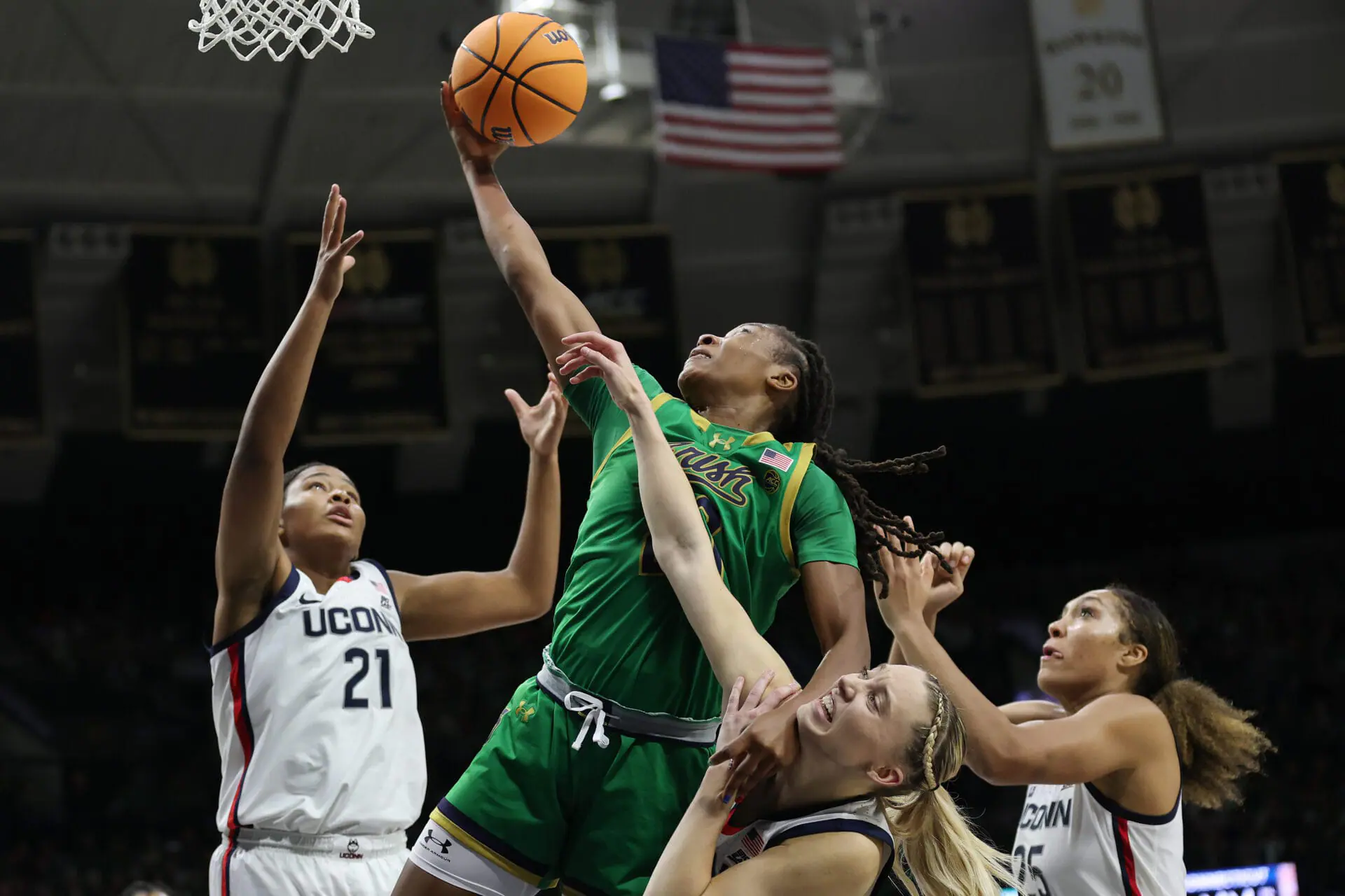 SOUTH BEND, INDIANA - DECEMBER 12: Liatu King #20 of the Notre Dame Fighting Irish grabs a rebound against Sarah Strong #21, Paige Bueckers #5 and Ice Brady #25 of the UConn Huskies during the second half at Purcell Pavilion at the Joyce Center on December 12, 2024 in South Bend, Indiana. (Photo by Michael Reaves/Getty Images)