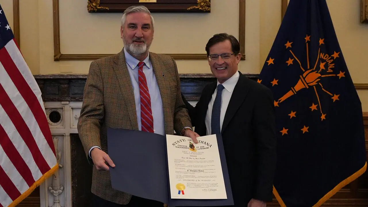 Indiana Governor Eric Holcomb (left) presents the Sagamore of the Wabash, the state's highest civilian honor, to Indianapolis Motor Speedway President J. Douglas Boles. (Provided Photo/IMS)